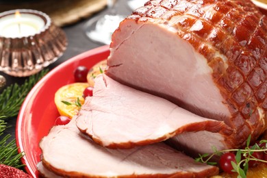 Tasty baked ham served on black wooden table, closeup