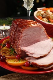 Tasty baked ham served on black table, closeup