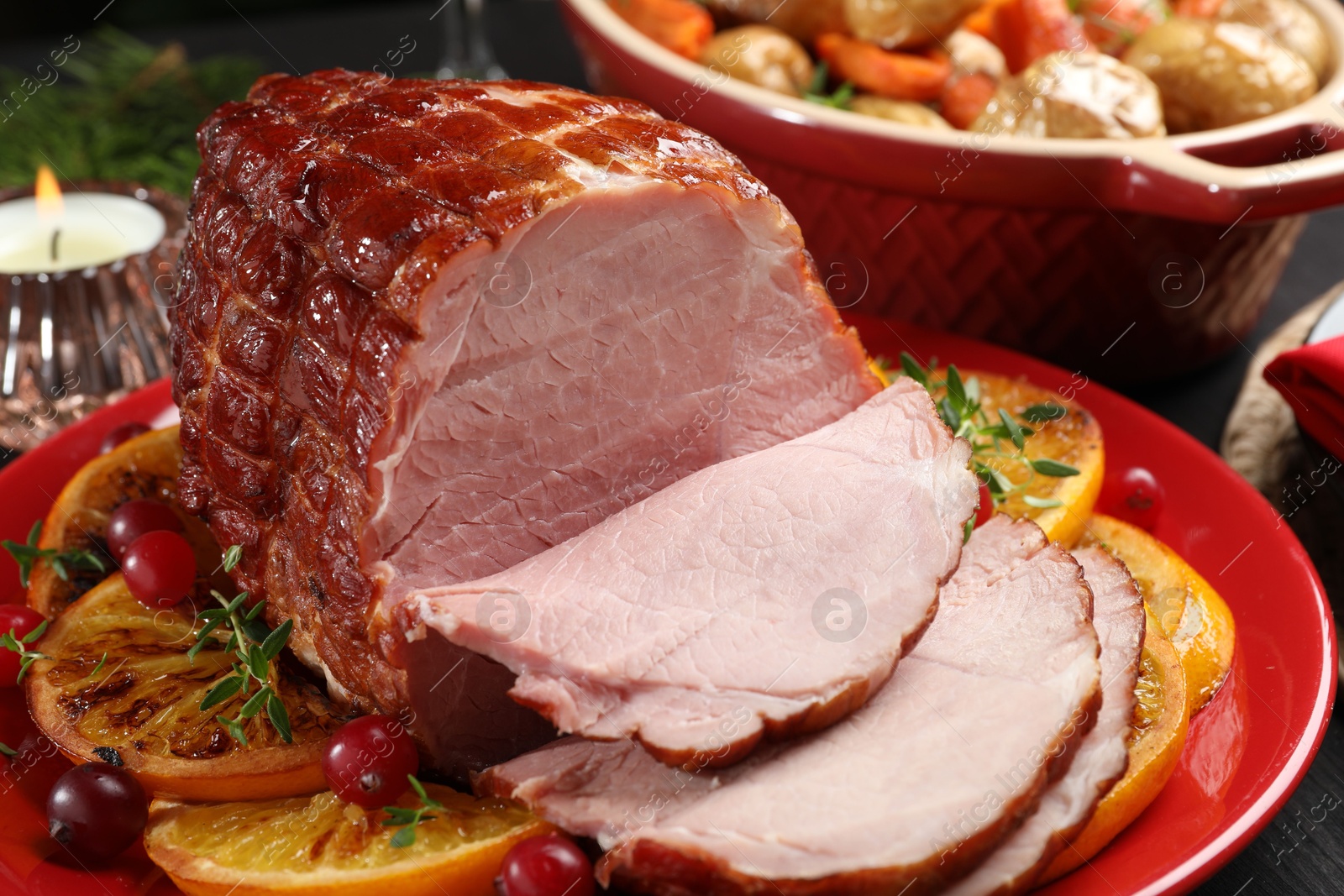 Photo of Tasty baked ham served on black table, closeup