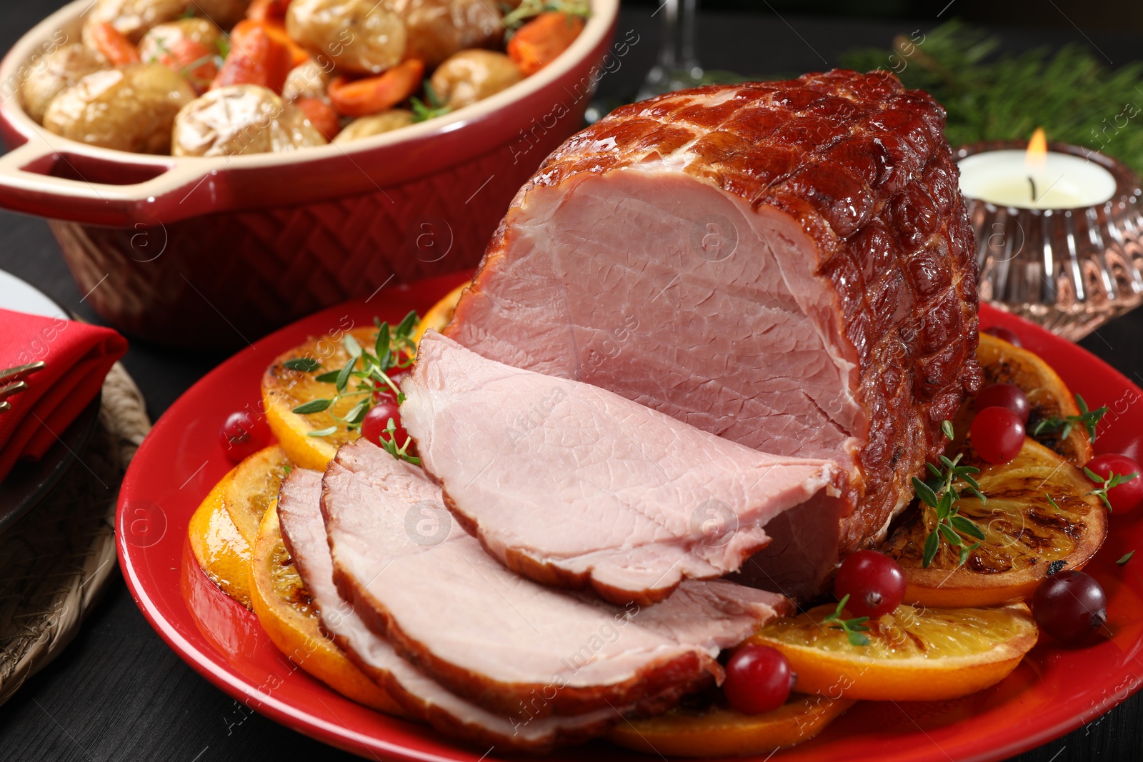 Photo of Tasty baked ham served on black wooden table, closeup