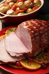 Photo of Tasty baked ham served on black table, closeup