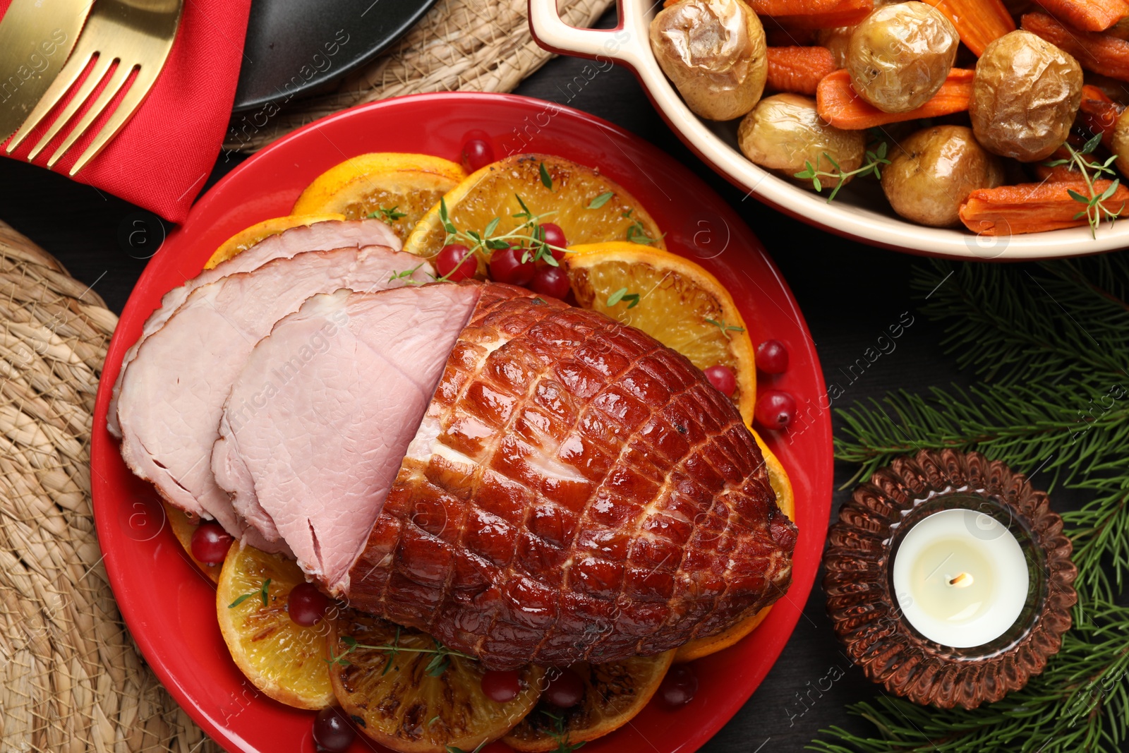 Photo of Tasty baked ham served on black wooden table, flat lay