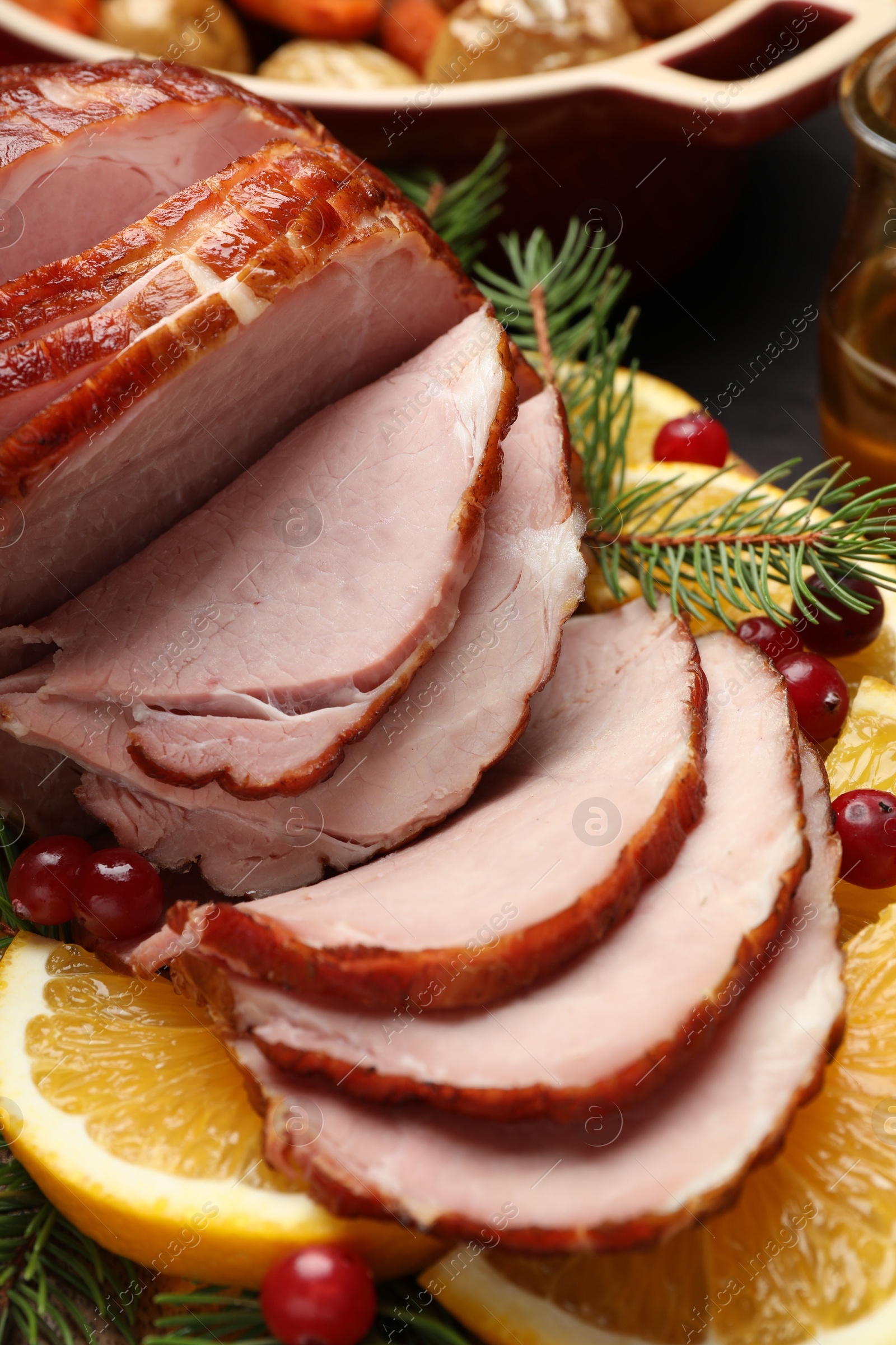 Photo of Tasty baked ham served on black wooden table, closeup