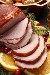 Tasty baked ham served on black wooden table, closeup