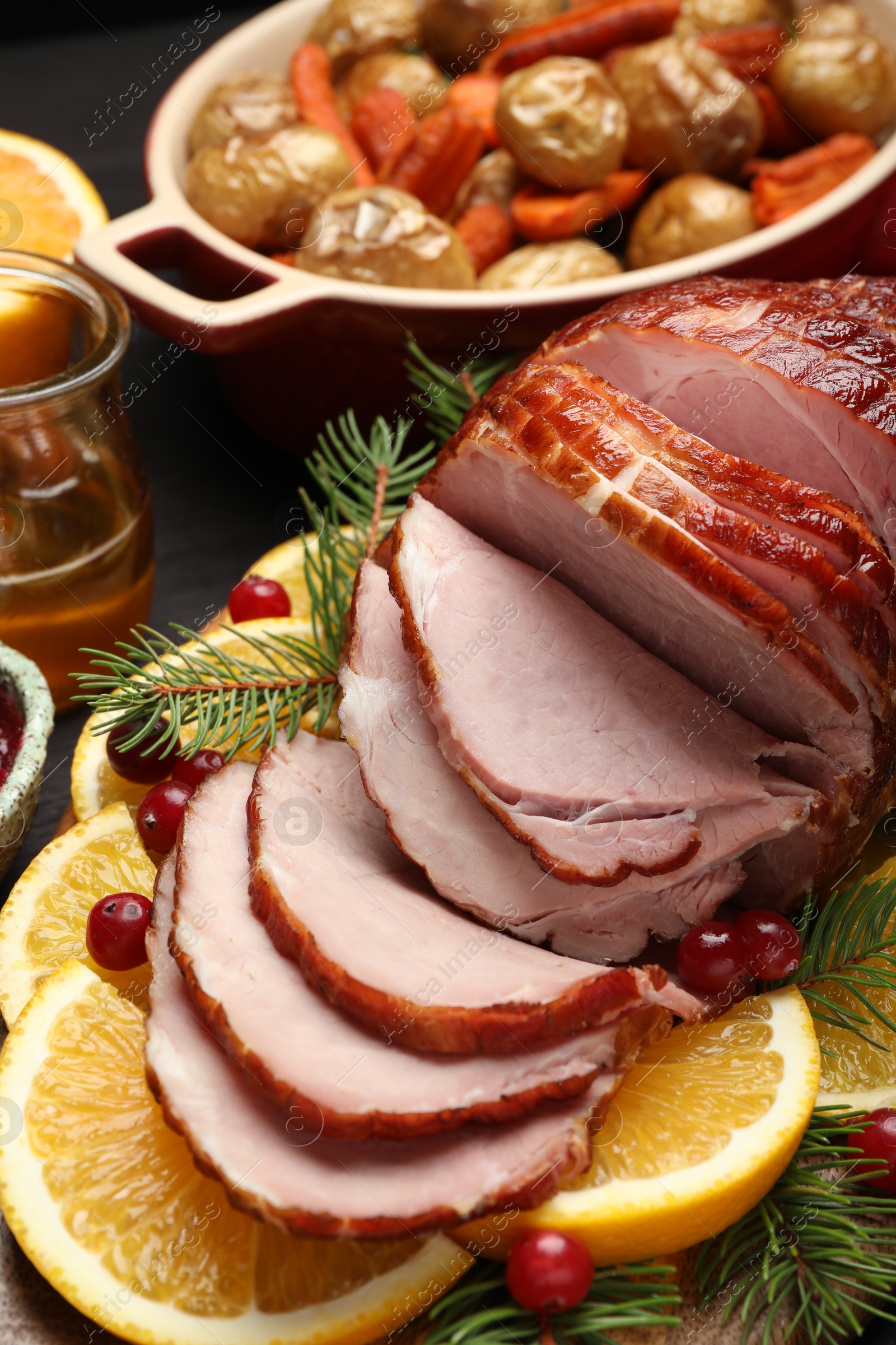 Photo of Tasty baked ham served on black wooden table, closeup