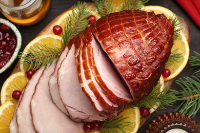 Tasty baked ham served on black wooden table, flat lay