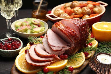 Tasty baked ham served on black wooden table