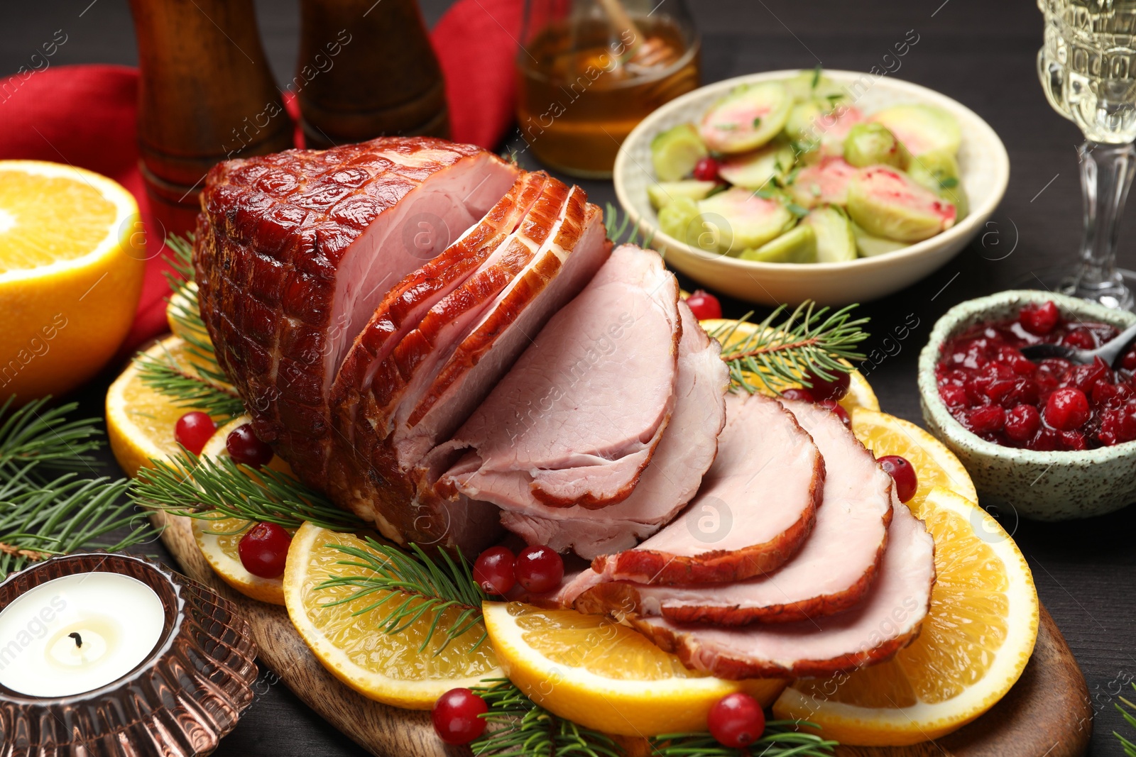 Photo of Tasty baked ham served on black wooden table, closeup