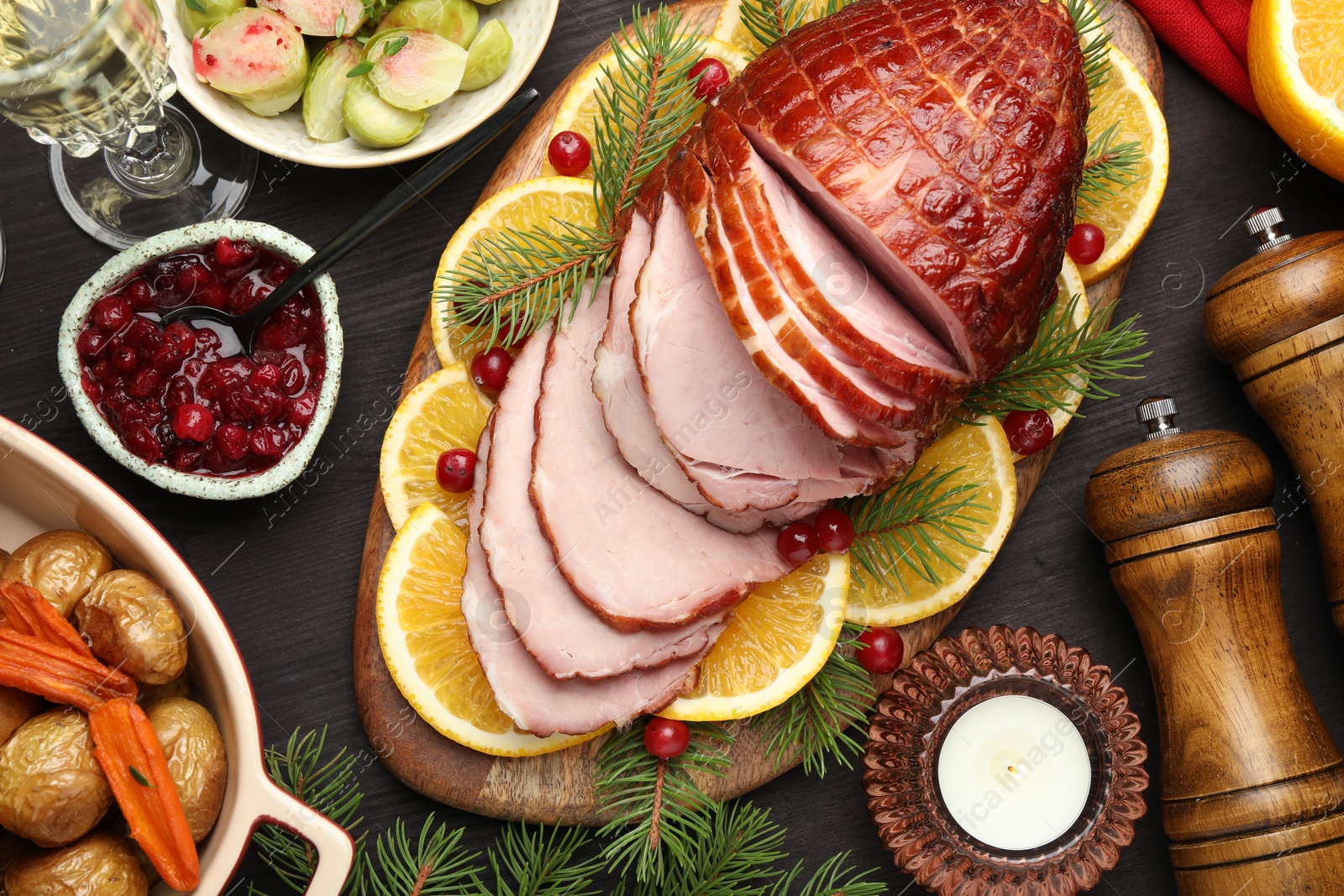 Photo of Tasty baked ham served on black wooden table, flat lay