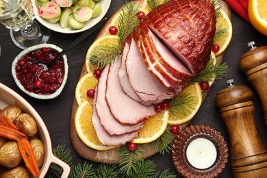 Tasty baked ham served on black wooden table, flat lay