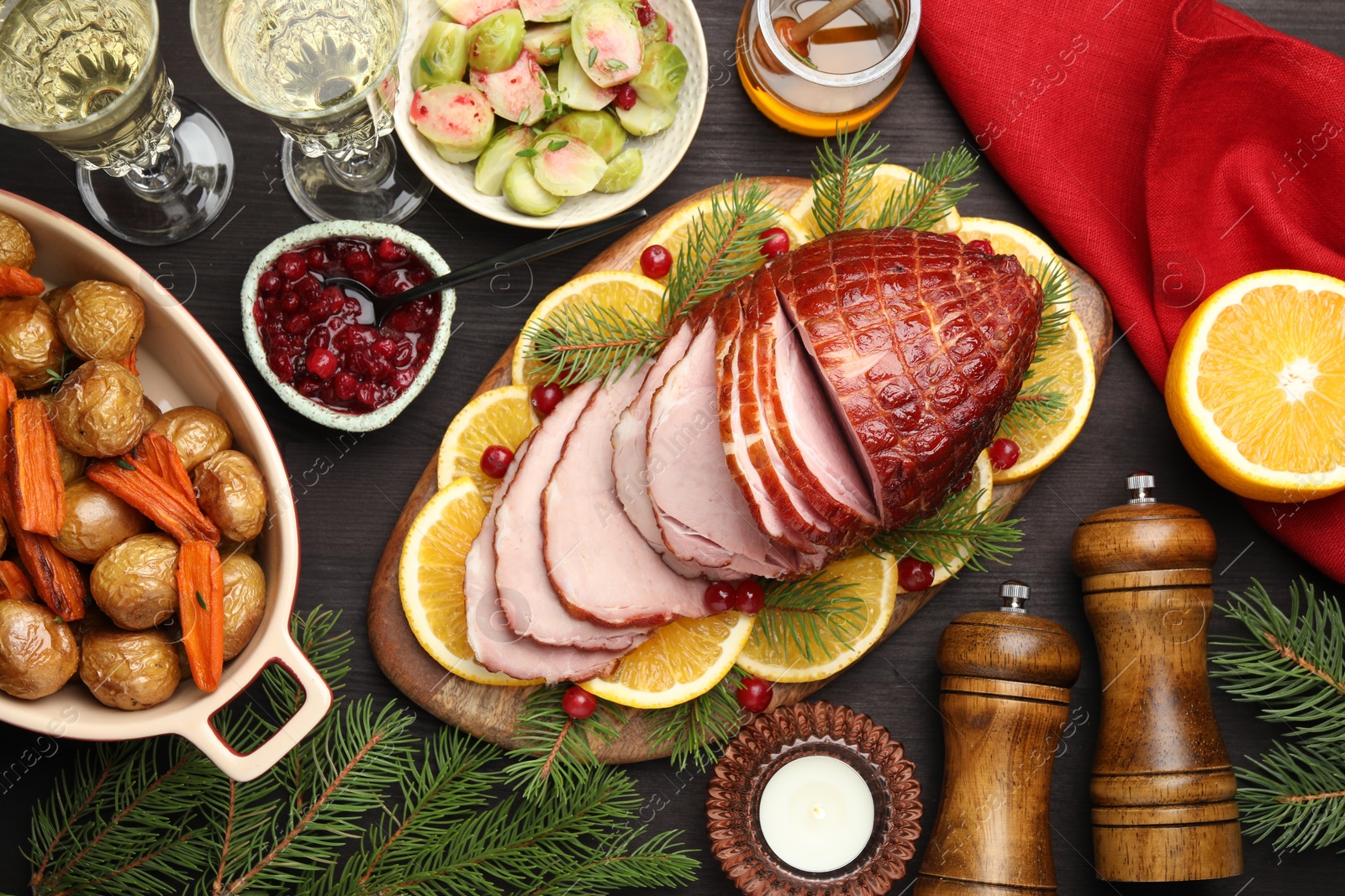 Photo of Tasty baked ham served on black wooden table, flat lay