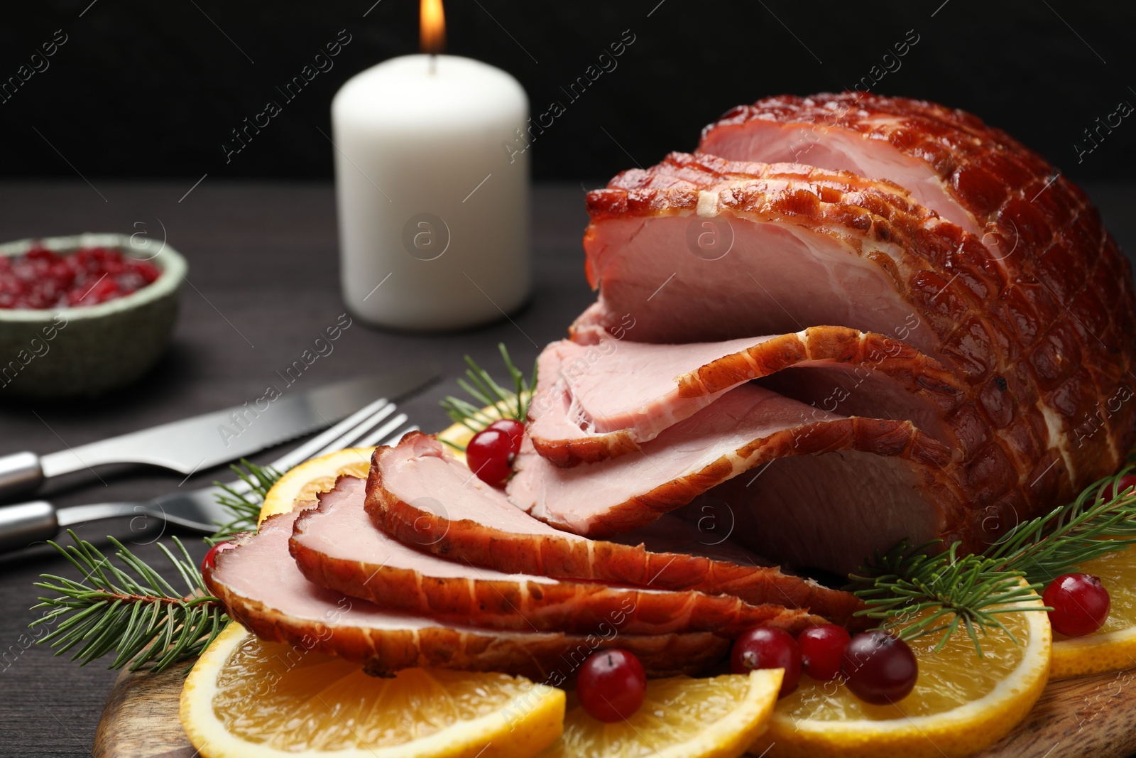 Photo of Tasty baked ham served on black wooden table, closeup