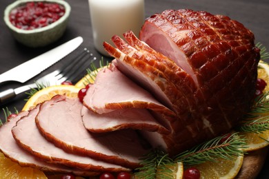 Tasty baked ham served on black table, closeup