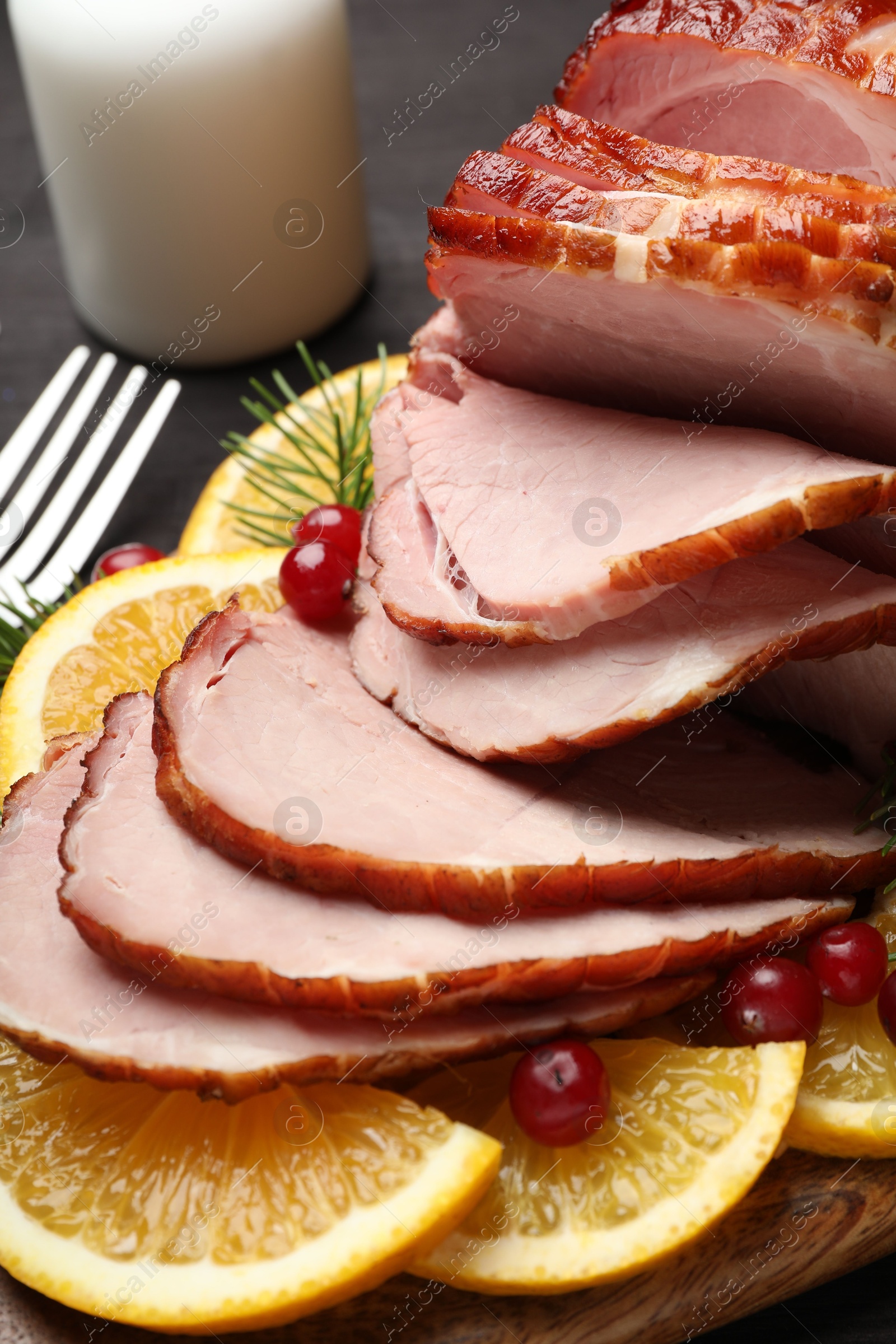 Photo of Tasty baked ham served on black table, closeup