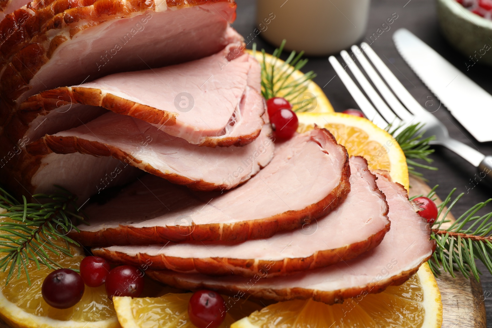 Photo of Tasty baked ham served on black table, closeup