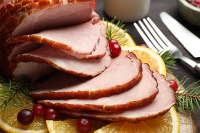 Tasty baked ham served on black table, closeup