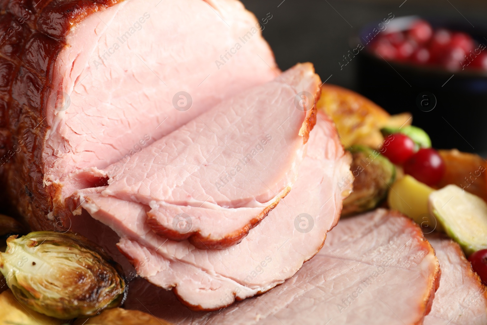 Photo of Tasty baked ham served with vegetables and oranges on table, closeup