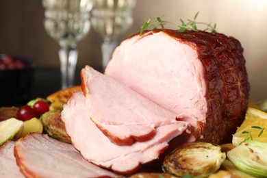 Tasty baked ham served with vegetables and oranges on table, closeup