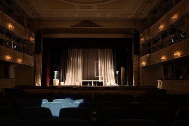 Photo of Theatre interior with stage and rows of comfortable seats