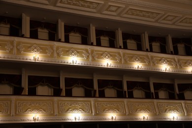 Photo of Balconies with vintage wall lamps in theatre