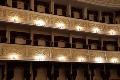 Photo of Balconies with vintage wall lamps in theatre