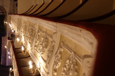 Photo of Vintage lamps on wall in theatre, selective focus