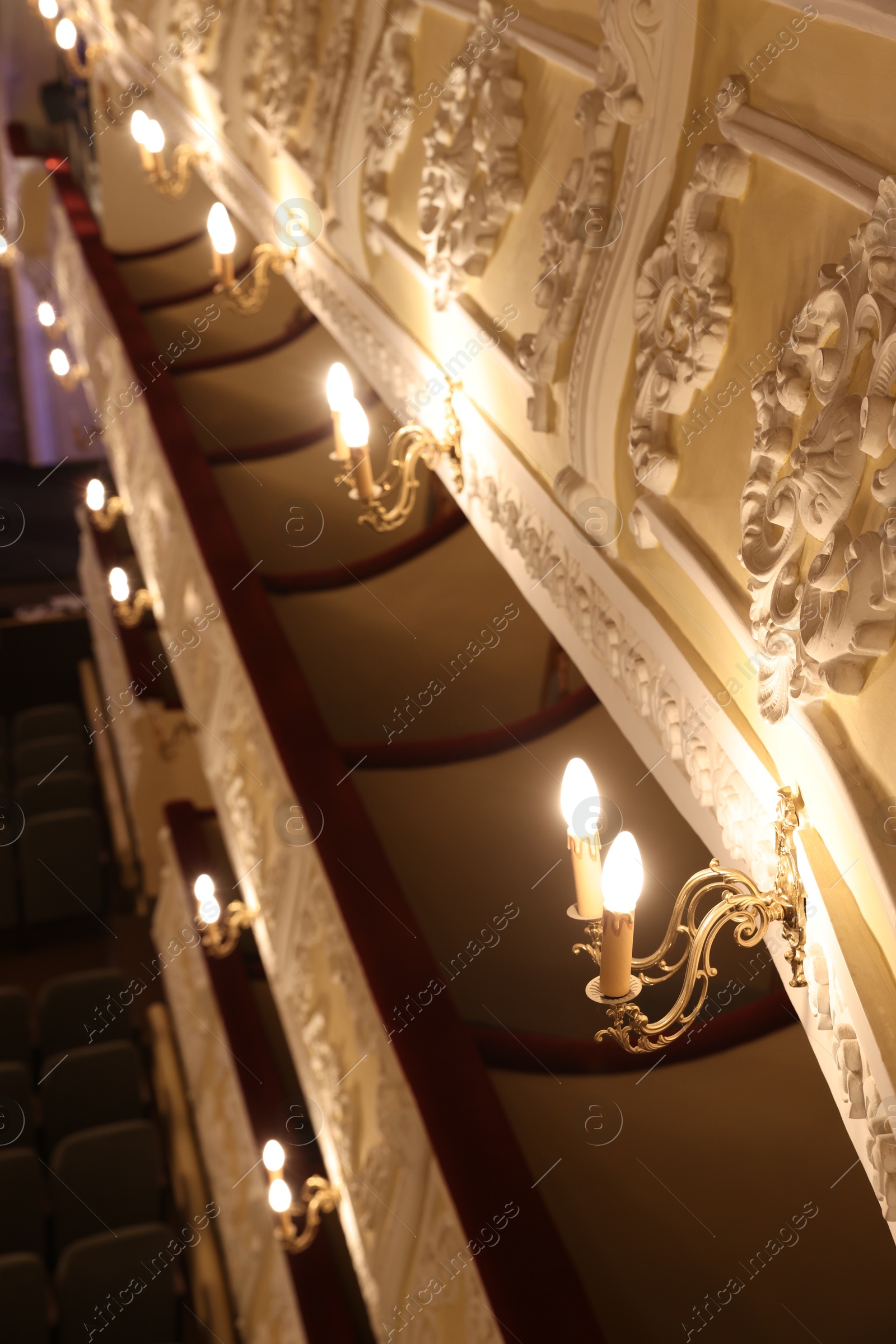 Photo of Vintage lamps on wall in theatre, selective focus