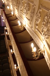 Photo of Vintage lamps on wall in theatre, selective focus