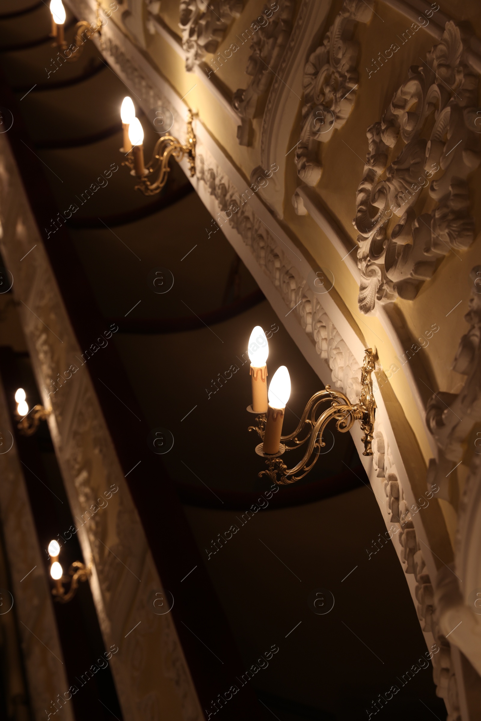 Photo of Vintage lamps on wall in theatre, selective focus