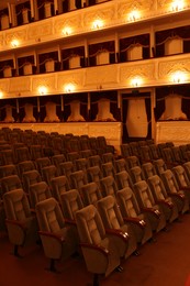 Photo of Rows of gray comfortable seats in theatre