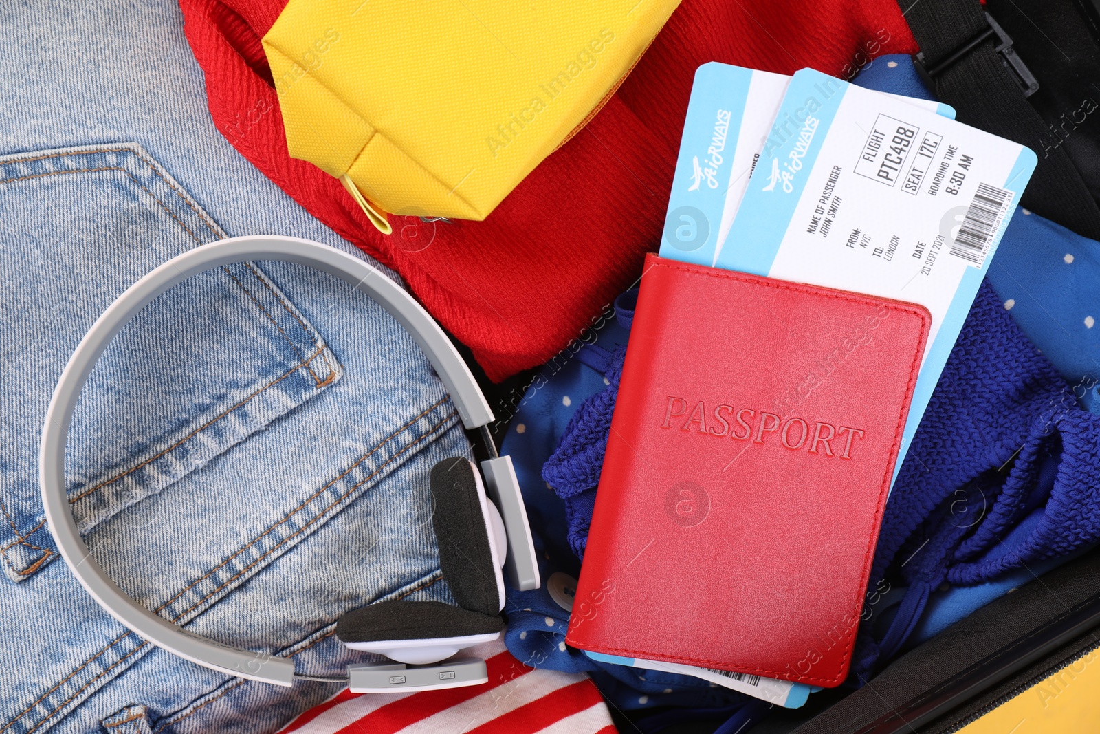 Photo of Travel abroad. Packed suitcase, passport and tickets, closeup view