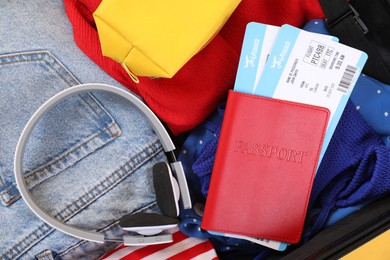 Travel abroad. Packed suitcase, passport and tickets, closeup view