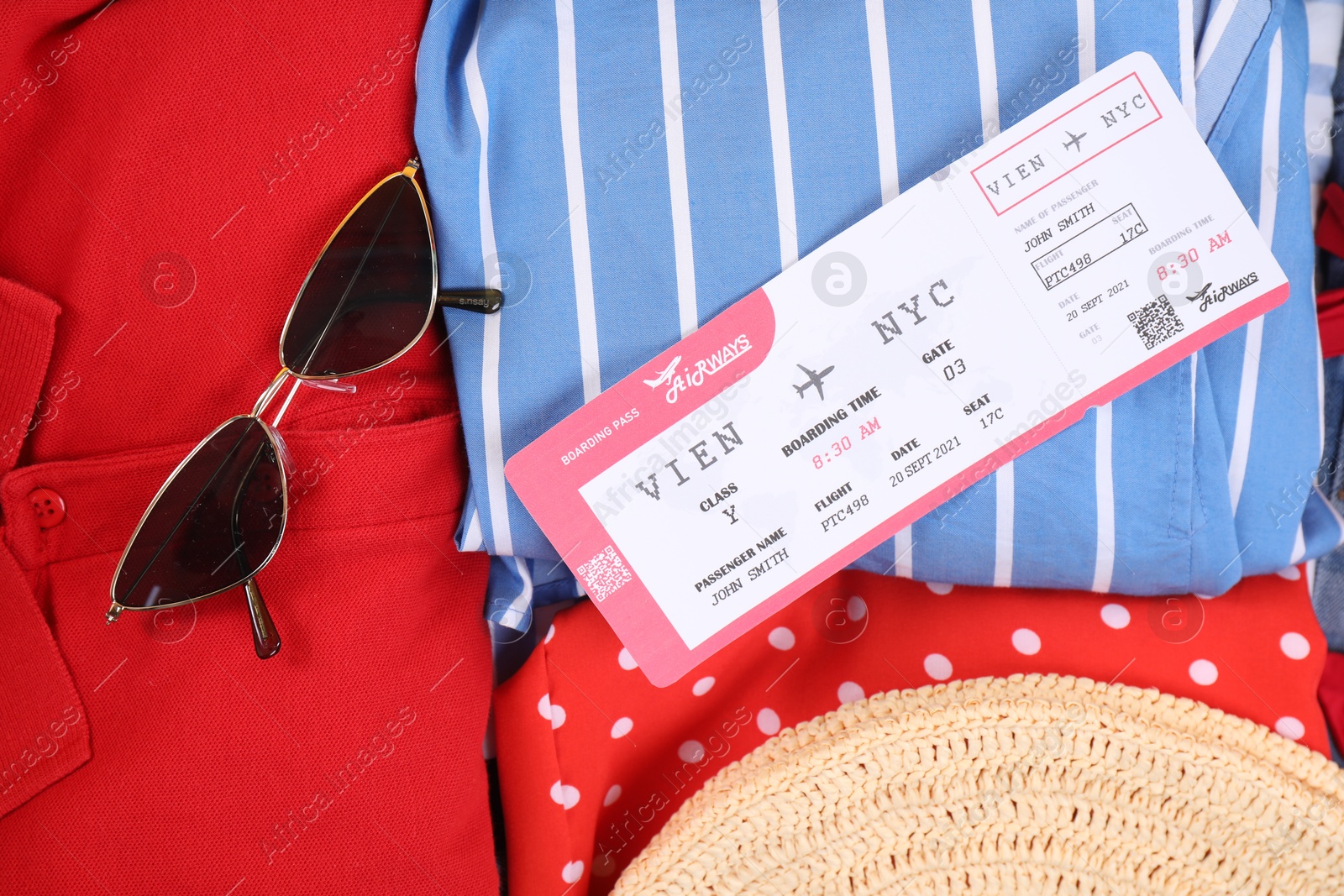 Photo of Different clothes, sunglasses and ticket as background, closeup. Travel luggage