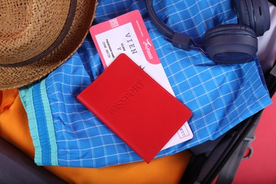 Photo of Different clothes, passport and ticket as background, closeup. Travel luggage