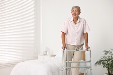 Photo of Senior woman with walking frame in hospital ward