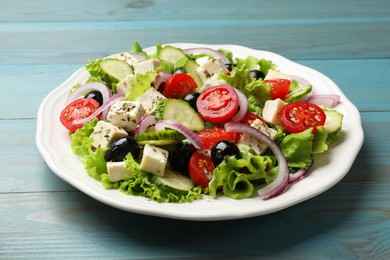 Photo of Delicious salad with feta cheese on wooden table, closeup