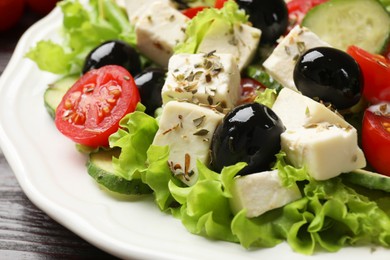 Photo of Delicious salad with feta cheese on table, closeup