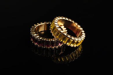 Beautiful bijouterie. Stylish rings on black background