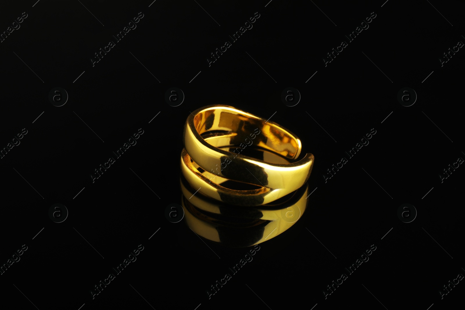 Photo of Beautiful bijouterie. Stylish ring on black background