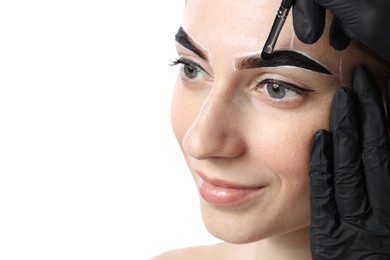 Photo of Young woman undergoing henna eyebrows dyeing on white background, closeup. Space for text