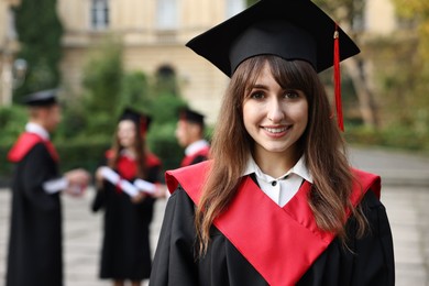 Photo of Graduation ceremony. Happy students outdoors, selective focus