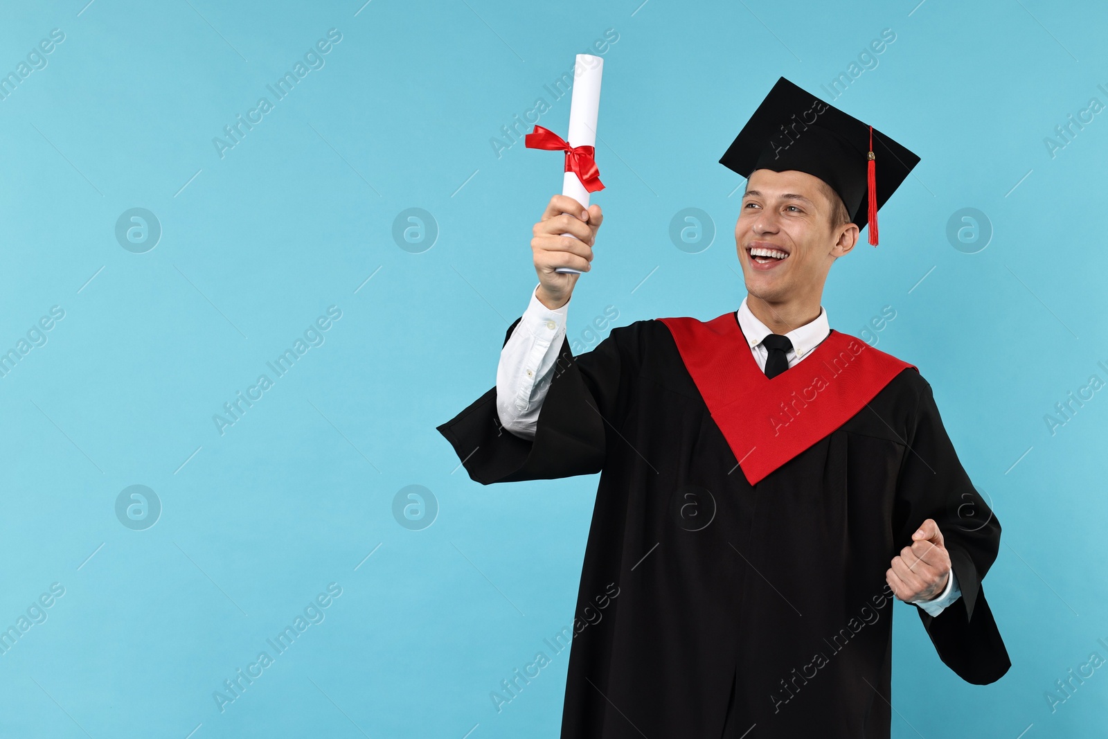 Photo of Happy student with diploma after graduation on light blue background. Space for text