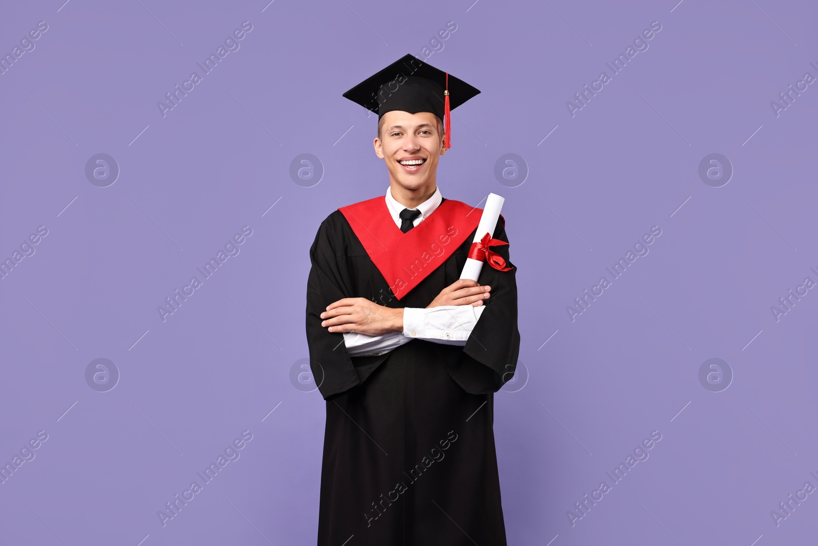 Photo of Happy student with diploma after graduation on violet background