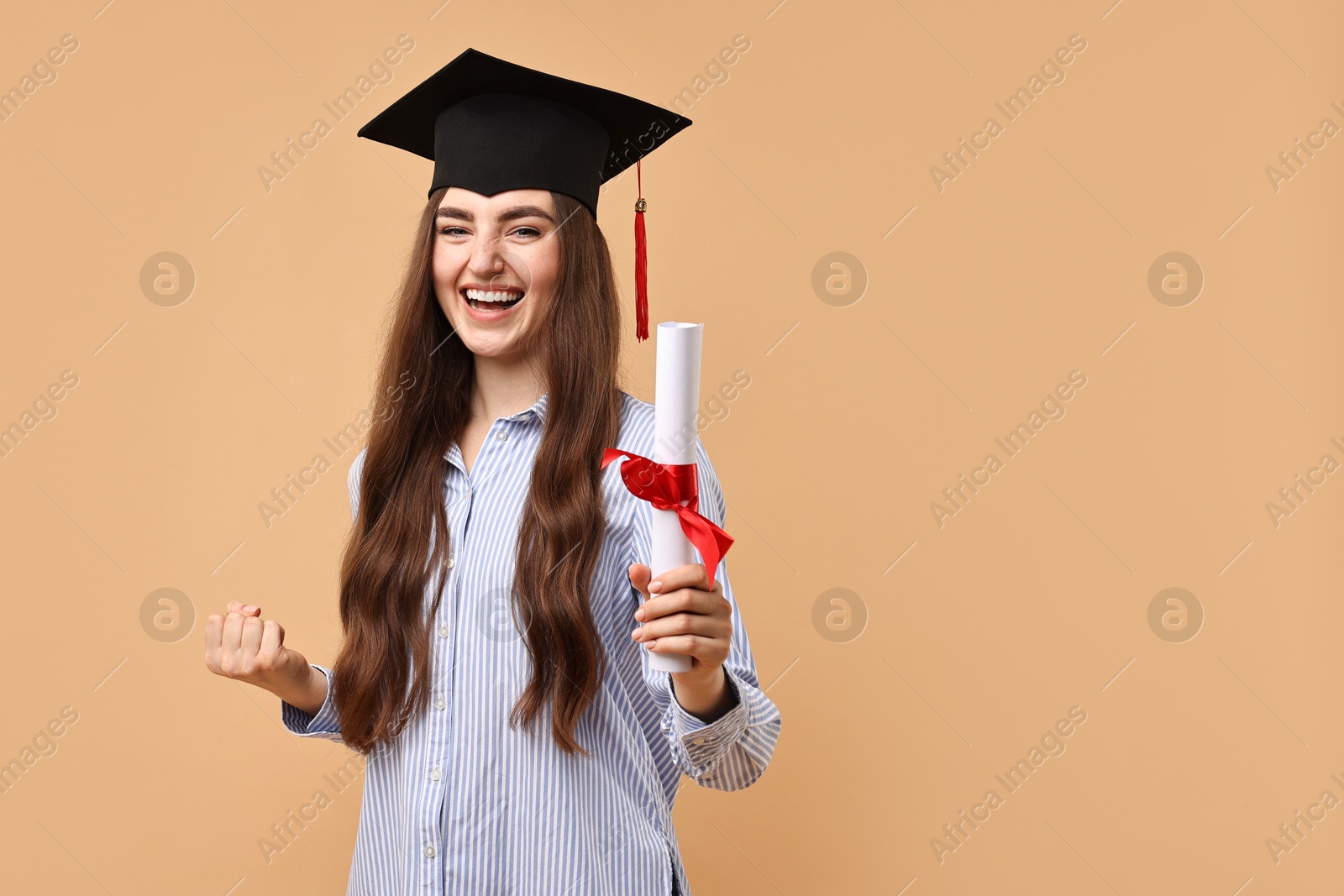 Photo of Happy student with diploma after graduation on beige background. Space for text