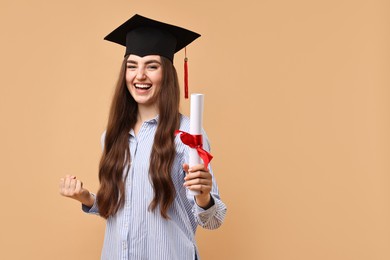 Photo of Happy student with diploma after graduation on beige background. Space for text