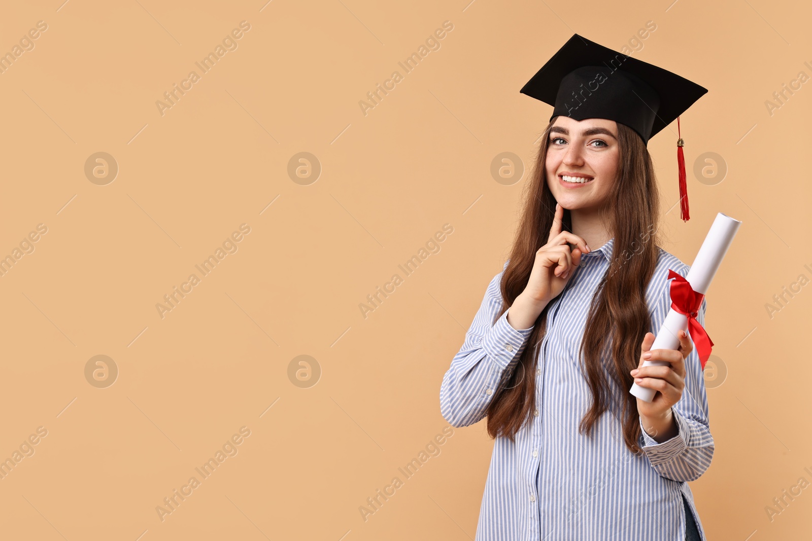 Photo of Happy student with diploma after graduation on beige background. Space for text