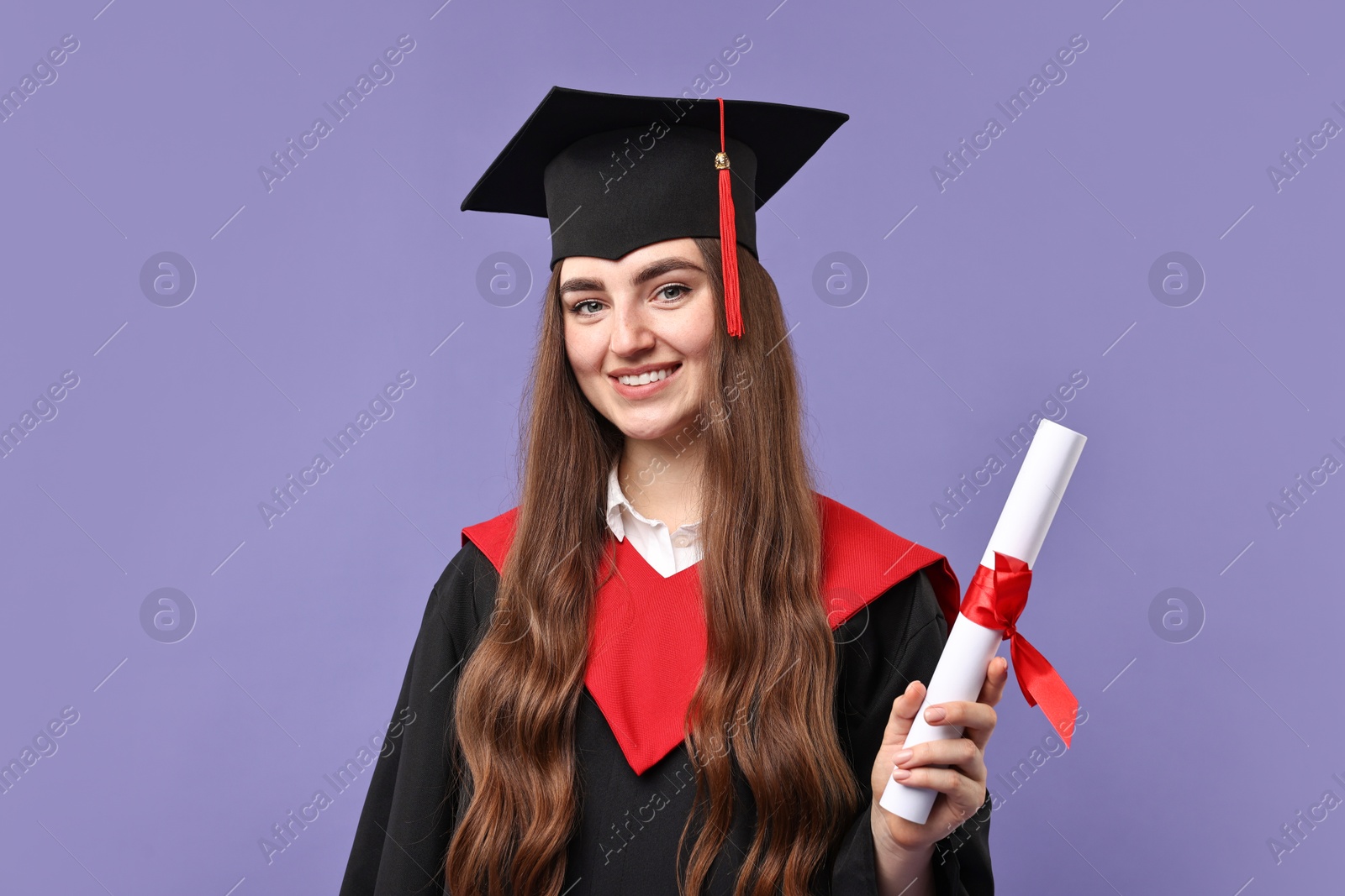 Photo of Happy student with diploma after graduation on violet background