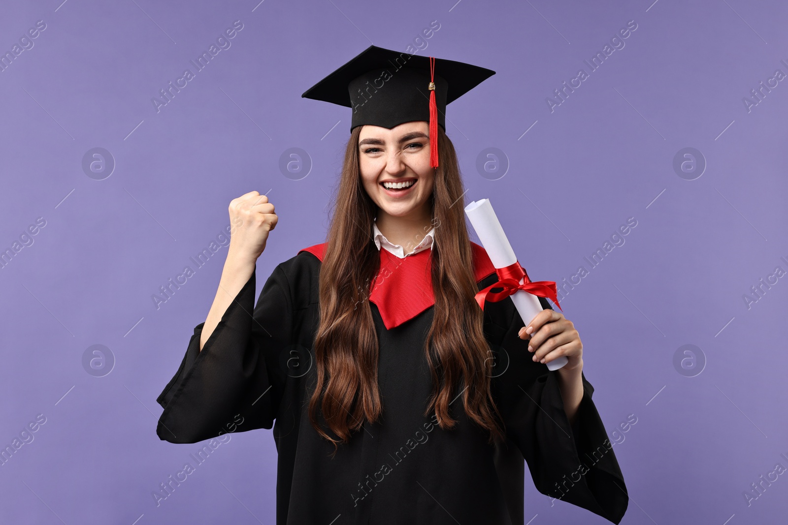 Photo of Happy student with diploma after graduation on violet background