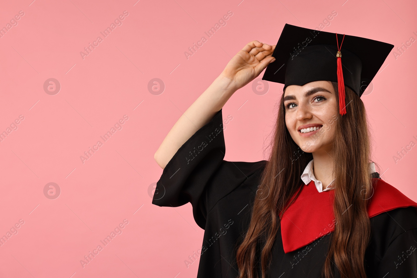 Photo of Happy student after graduation on pink background. Space for text