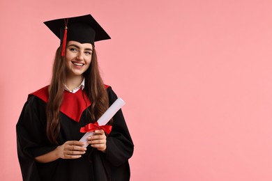 Photo of Happy student with diploma after graduation on pink background. Space for text